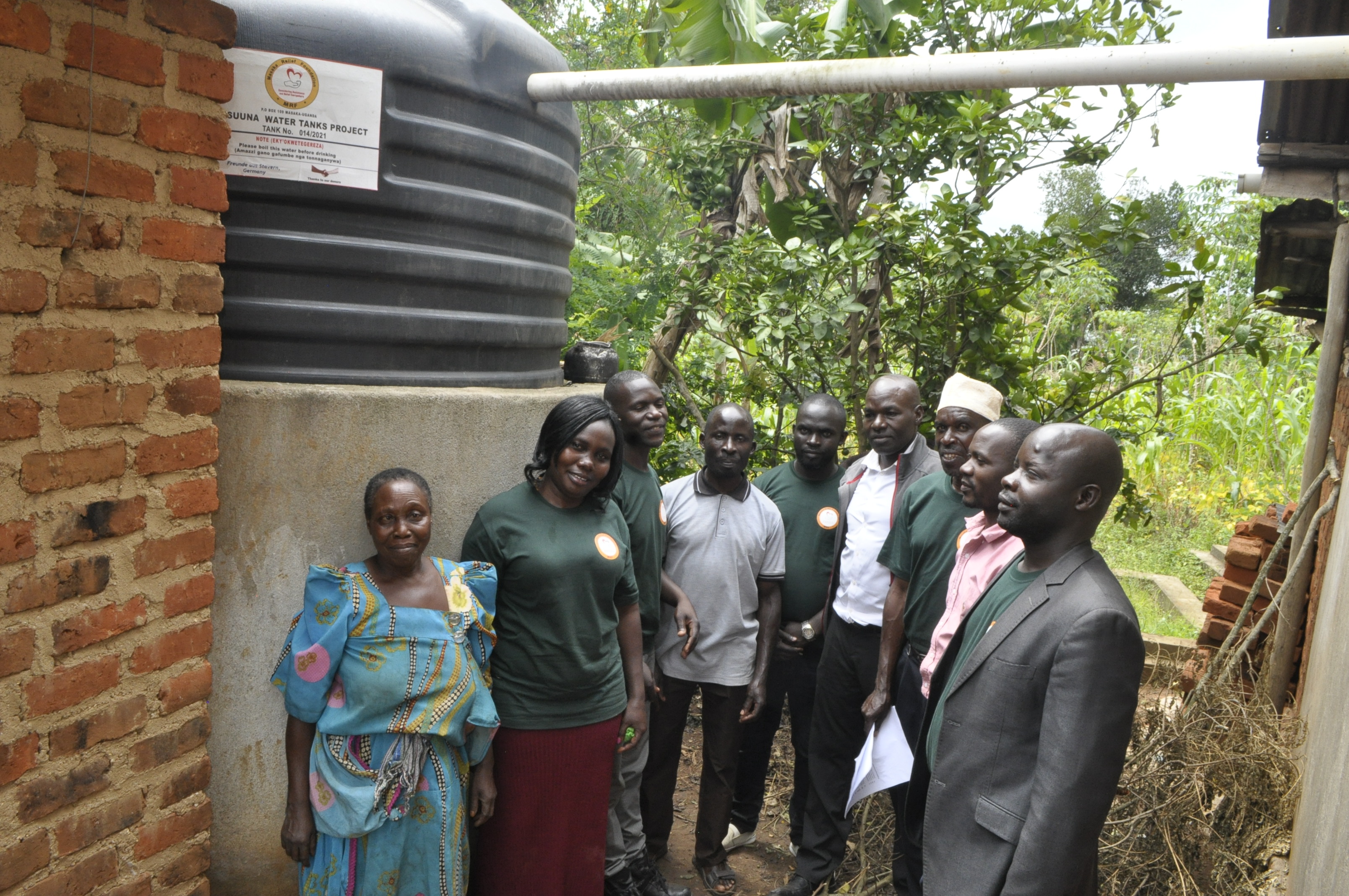 Masaka NGO Forum inspecting completed water tank at Nalongo's home