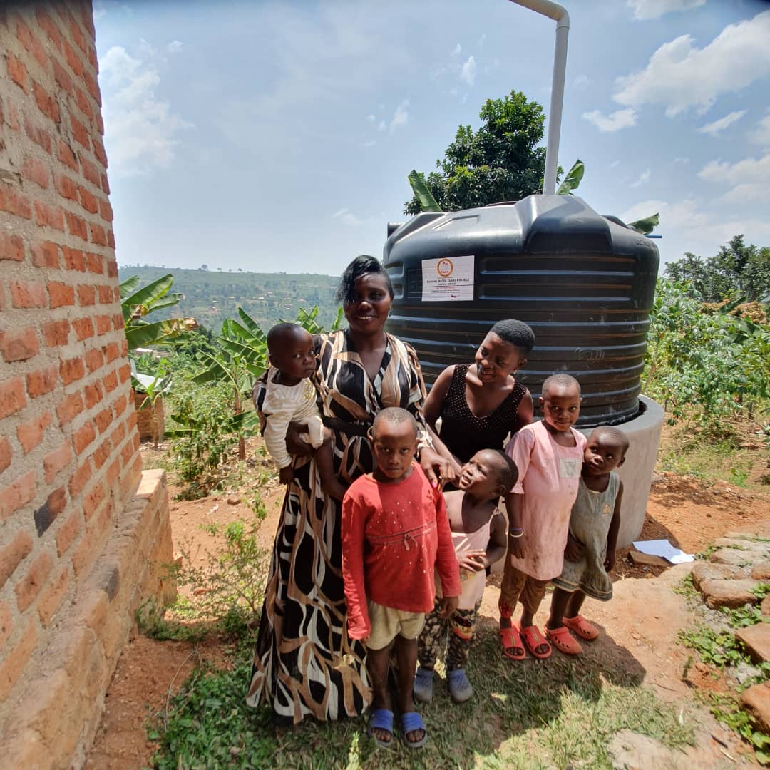 Family with newly installed water tank in rural setting