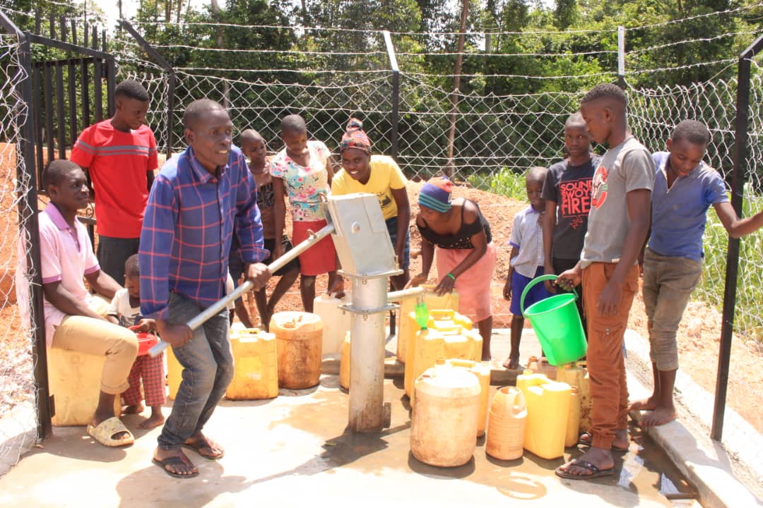 Community members accessing clean water at operational borehole